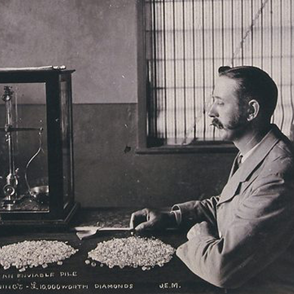 Photo of an employee of De Beers counting the diamonds mined that day.