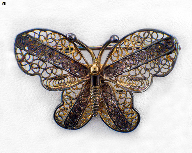 Image Showcasing Before #12 of a Tarnished Butterfly Brooch Getting Extreme Restoration Services by Master Jewelers