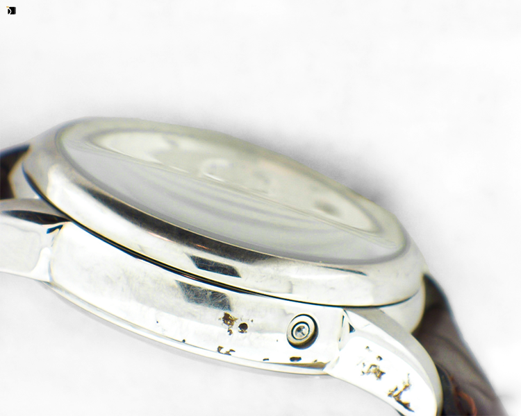Before #57 Side View of Carucci Timepiece with Scratches and Damage to Watch Case