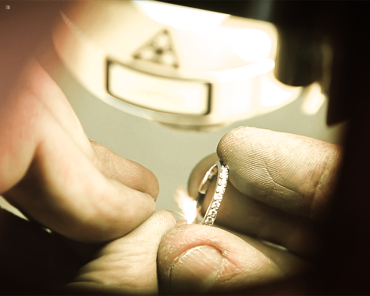Jeweler Using Laser Welding Machine on a Ring