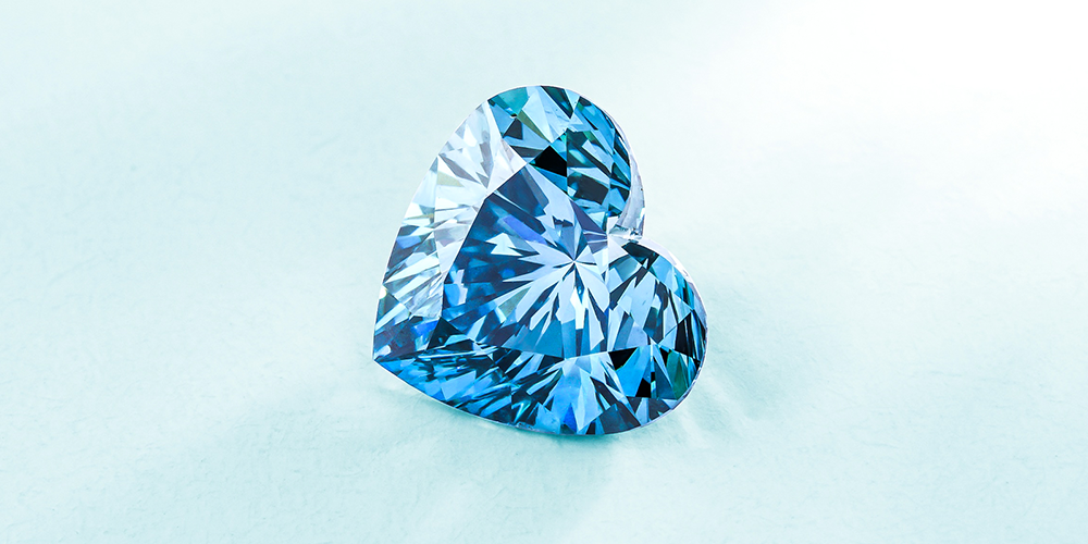 Polished Heart-Shaped Aquamarine Loose Gemstone Displayed on Baby Blue Background