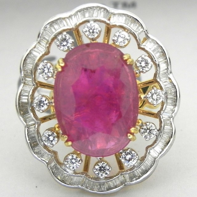 Photo showing cocktail ring surrounded by diamonds with large pink gemstone in the middle
