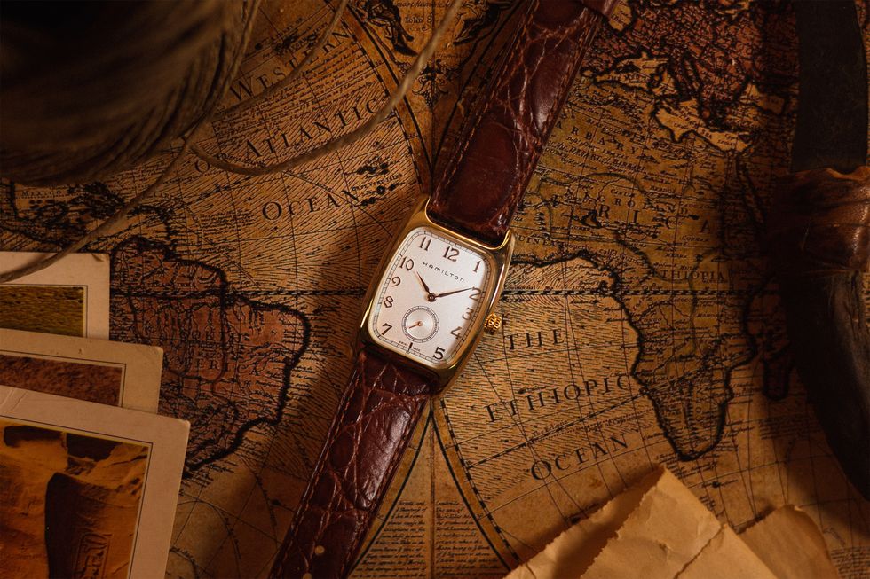 Photo by Gear Patrol of Hamilton Bultron Quartz Watch with leather straps on top of old vintage map
