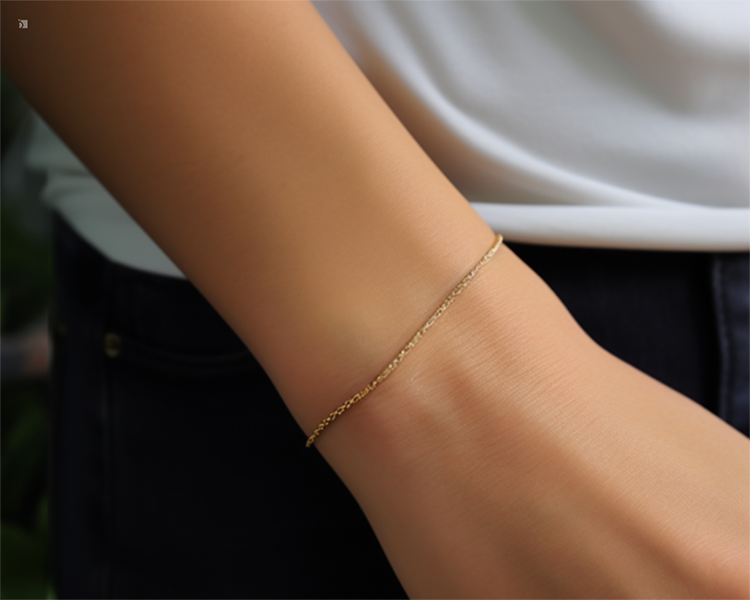 Dainty Gold Bracelet Permanent Jewelry Welded Onto A Person's Wrist Casual Outfit