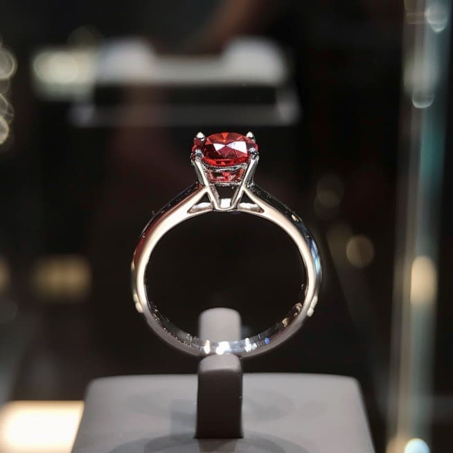 Photo of red diamond ring on display at auction.