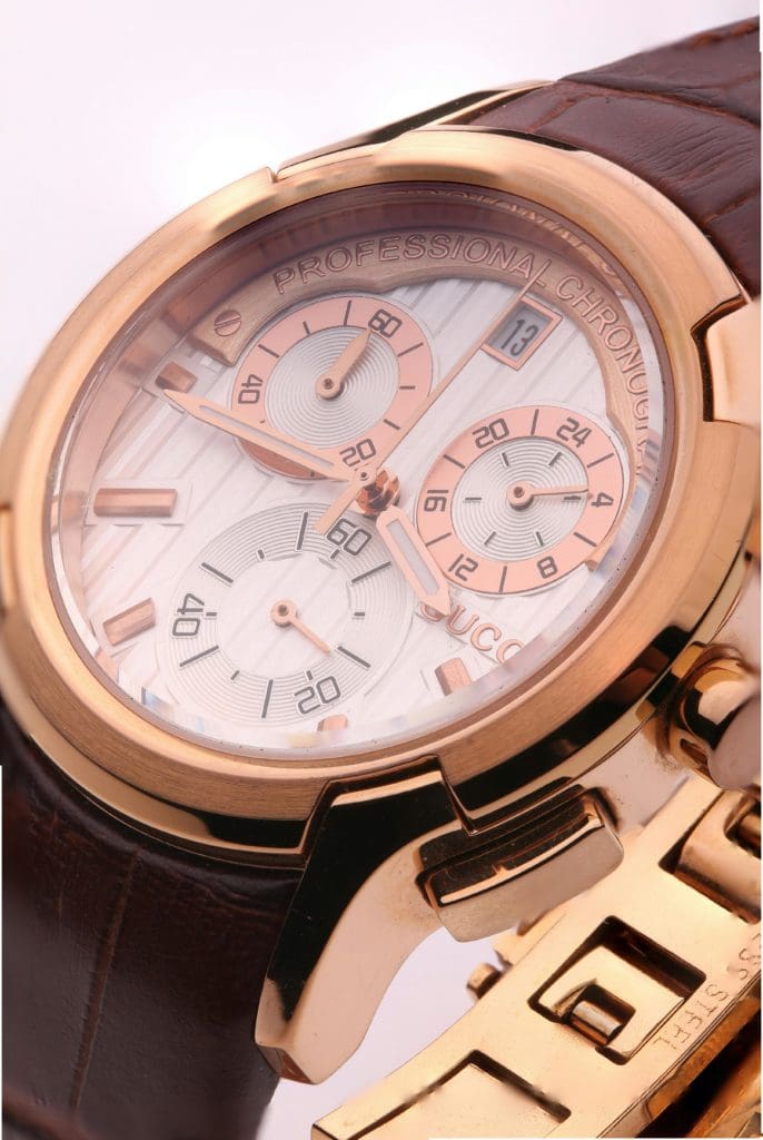 Photo of rose gold Gucci Watch dial close up.