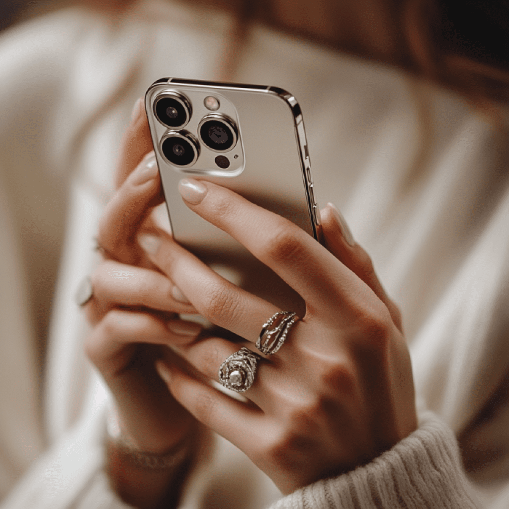 Image showcasing woman on iPhone wearing rings on hands