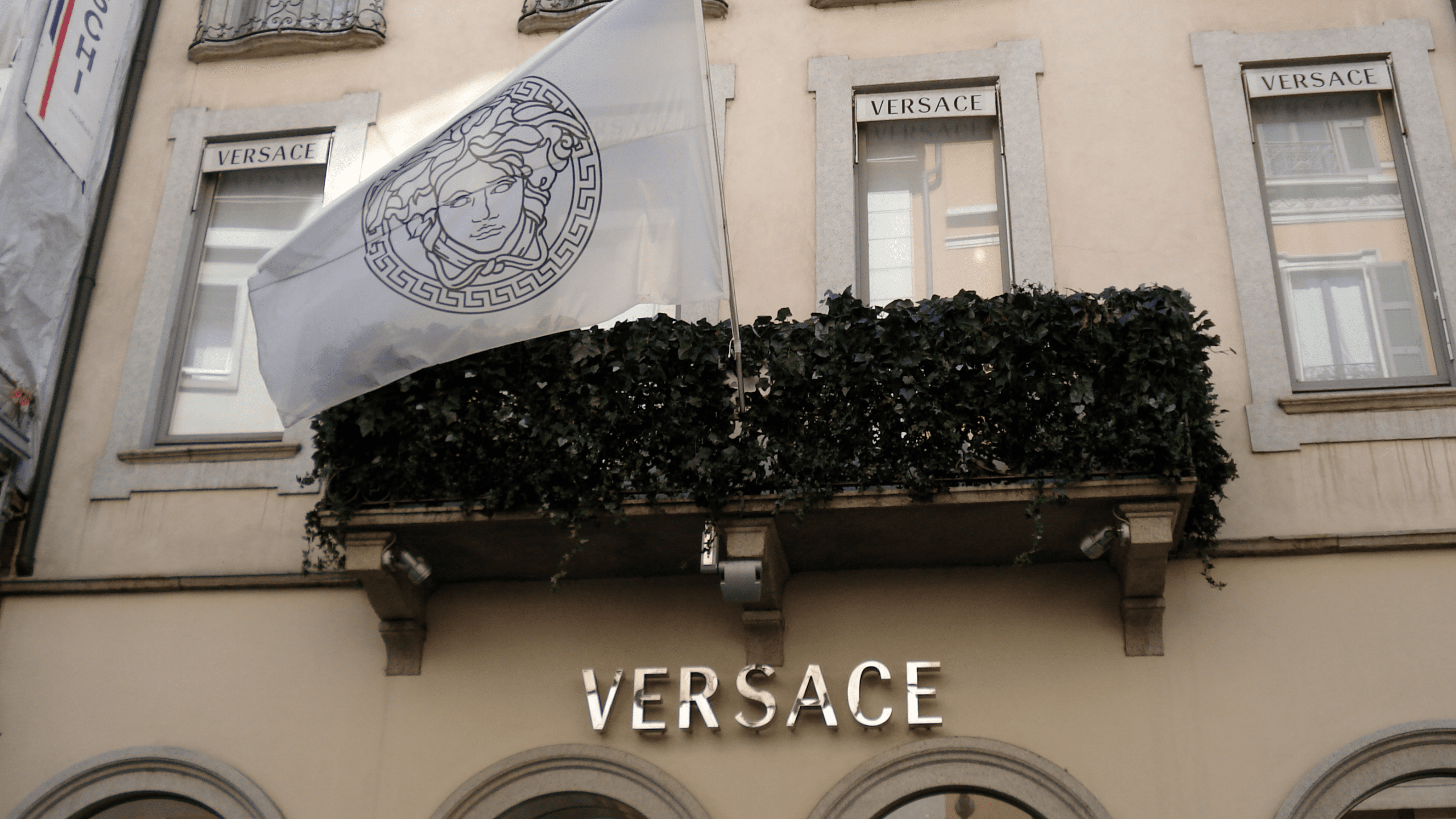 Image showing Versace store and flag with Medusa logo